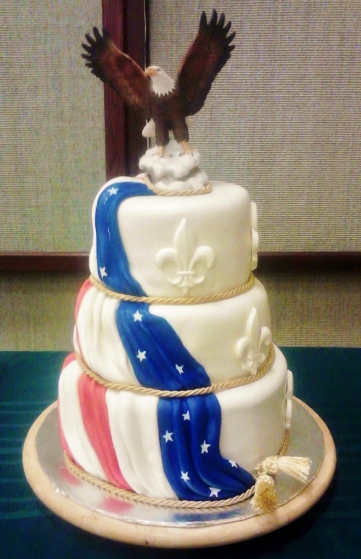 Vanilla, red velvet, and chocolate tiers covered in mm fondant with white chocolate fleur di lis.